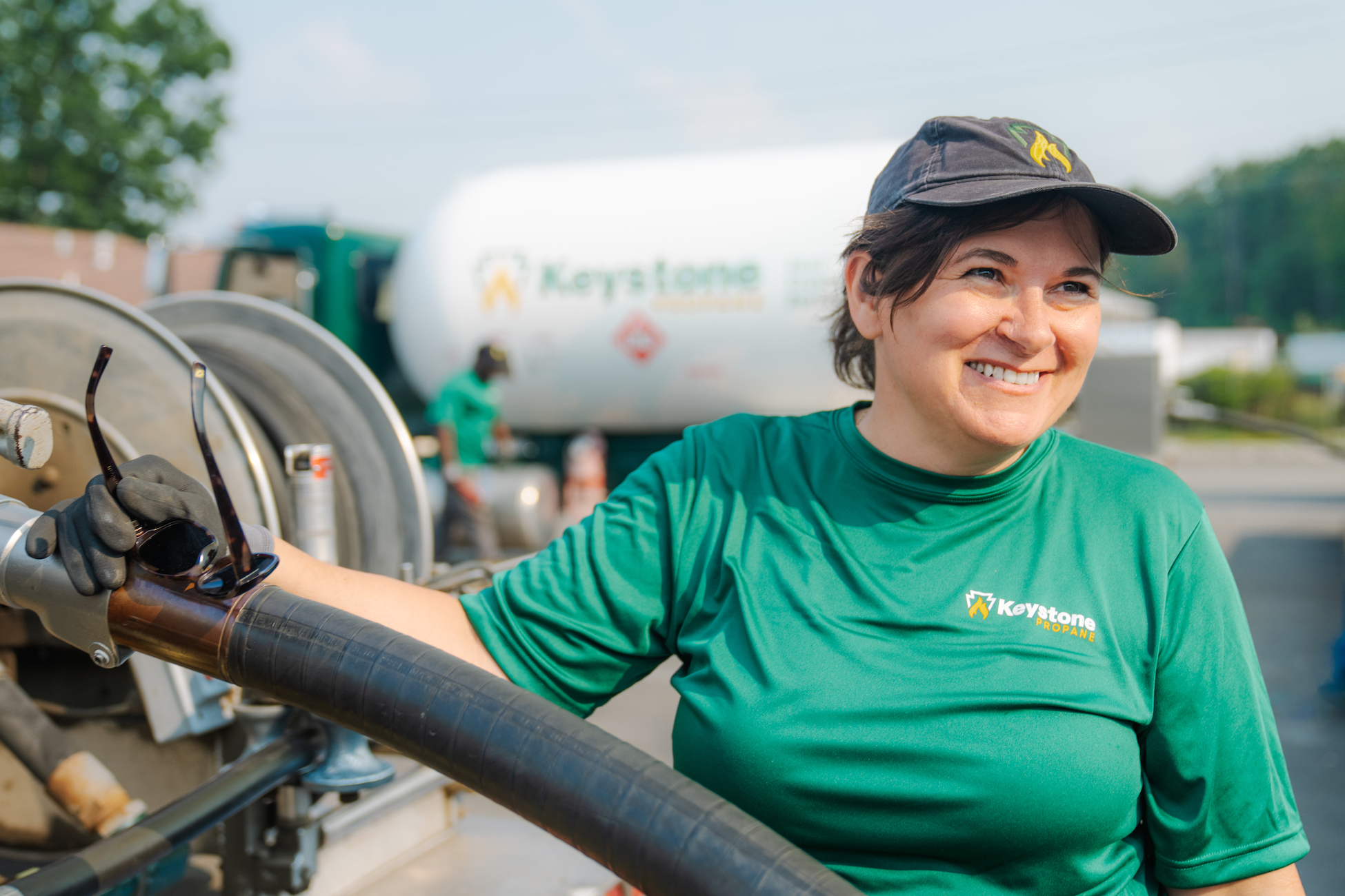 Keystone Propane technician smiling while gathering hose from tanker. (custom photography)