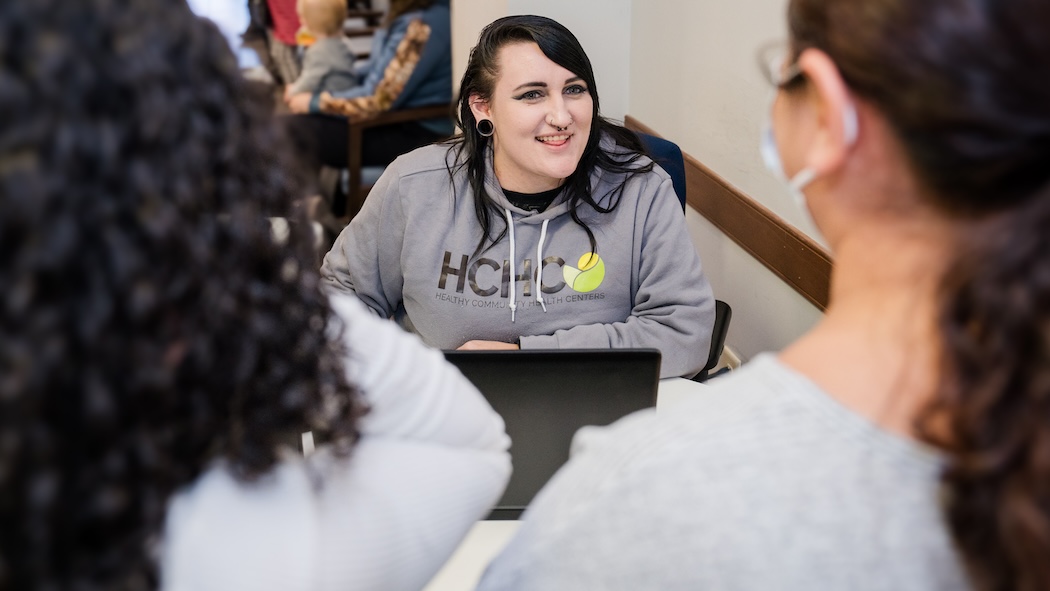 HCHC employee sitting at laptop intaking a new patient